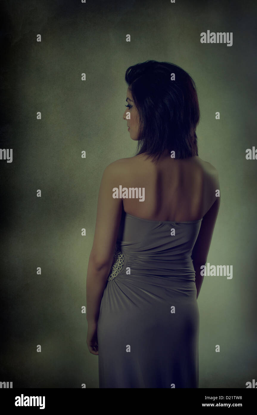Rear view of a young woman looking away Stock Photo - Alamy