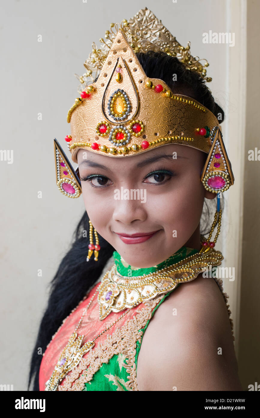 A young woman in traditional dress poses before joining a Harvest Festival parade in the village of Tumpang, Java, Indonesia Stock Photo