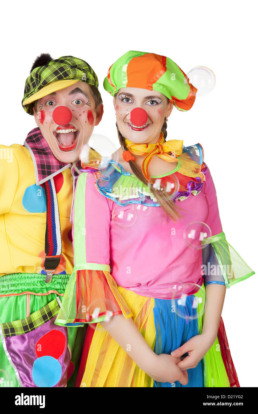 Two cheerful clowns in the soap bubbles isolated on a white background ...