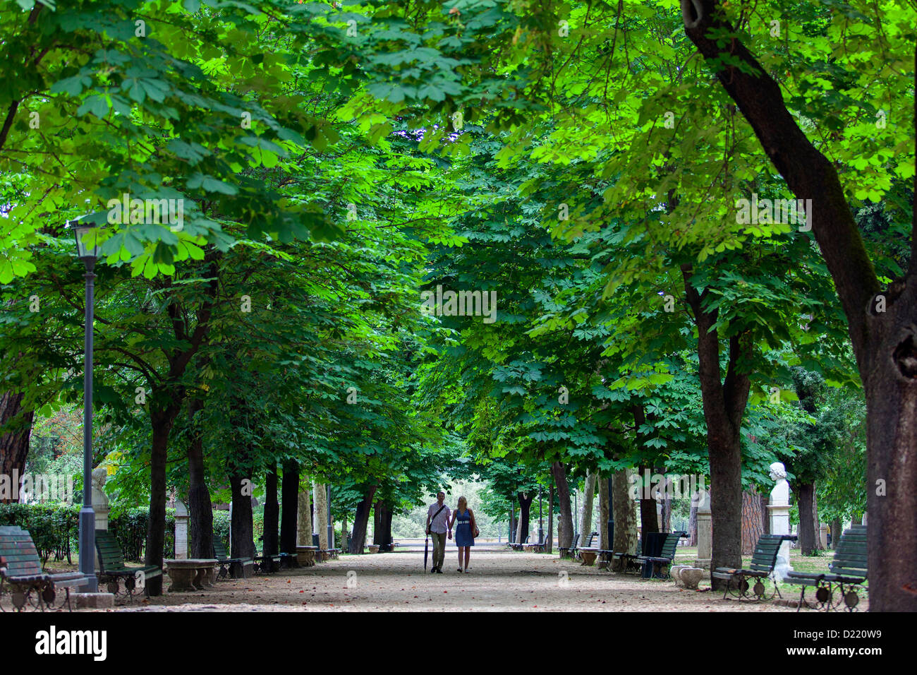 Couple walking hand in hand in a park Stock Photo