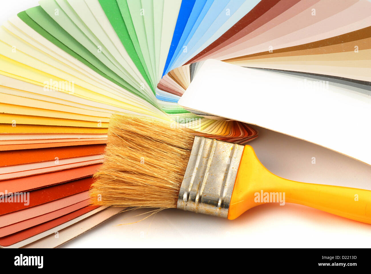 Paint brush laying on a heap of color samples Stock Photo Alamy