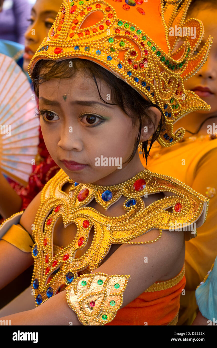 A young girl in traditional costume takes part in a Harvest Festival ...