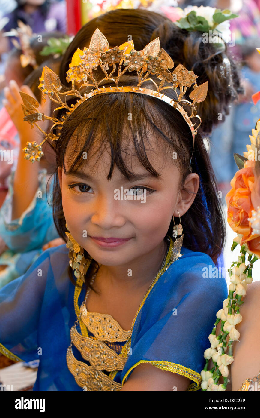 A young girl in traditional costume takes part in a Harvest Festival ...