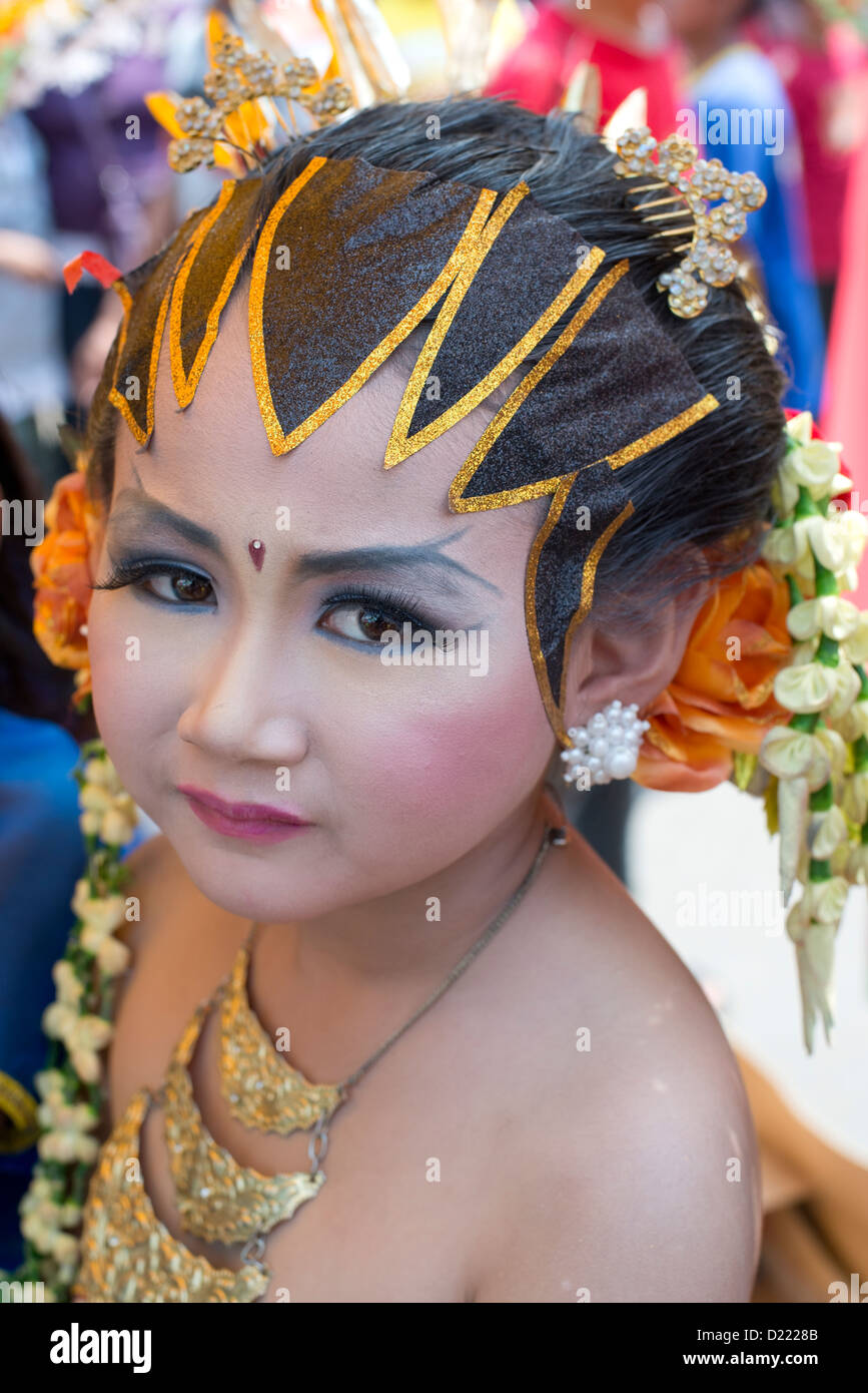 A young girl in traditional costume takes part in a Harvest Festival ...