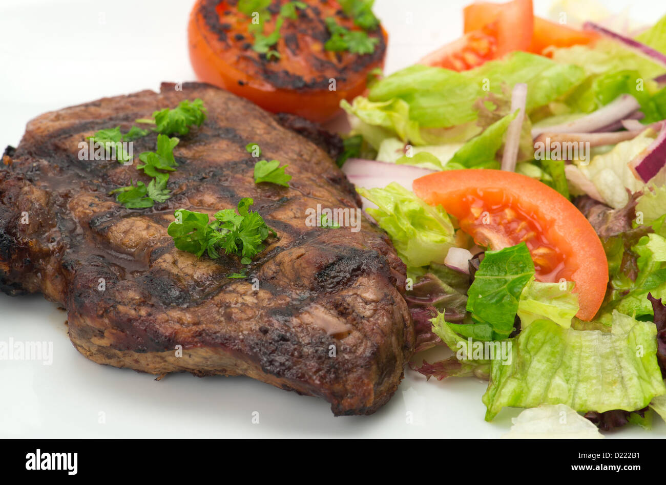 Grilled New York rump steak and salad - studio shot Stock Photo