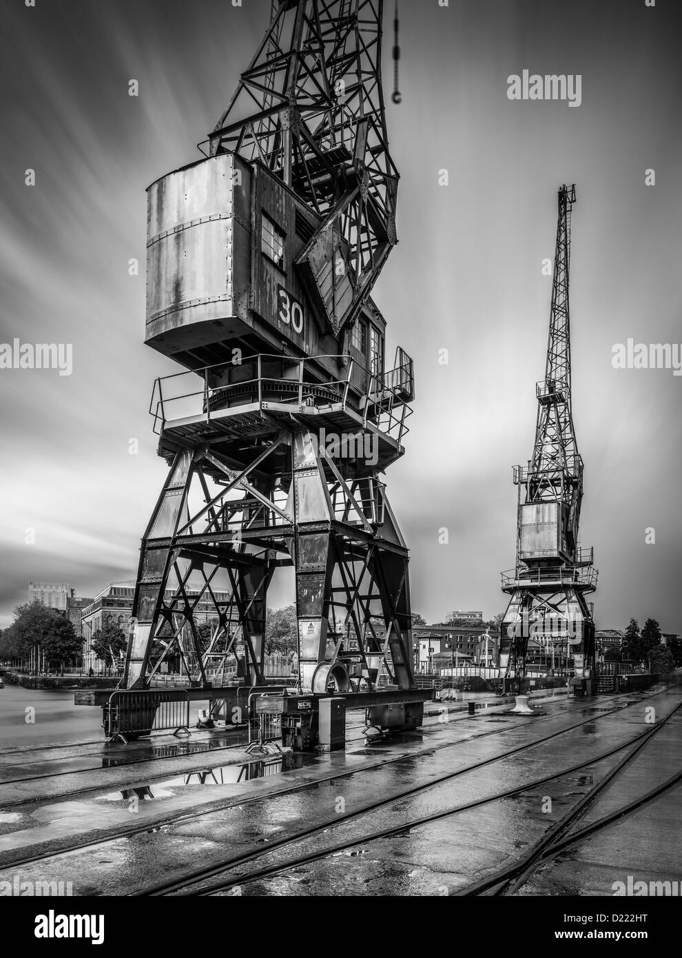 Bristol harbour cranes and railway tracks after a rain storm at Bristol harbour, Bristol, UK Stock Photo