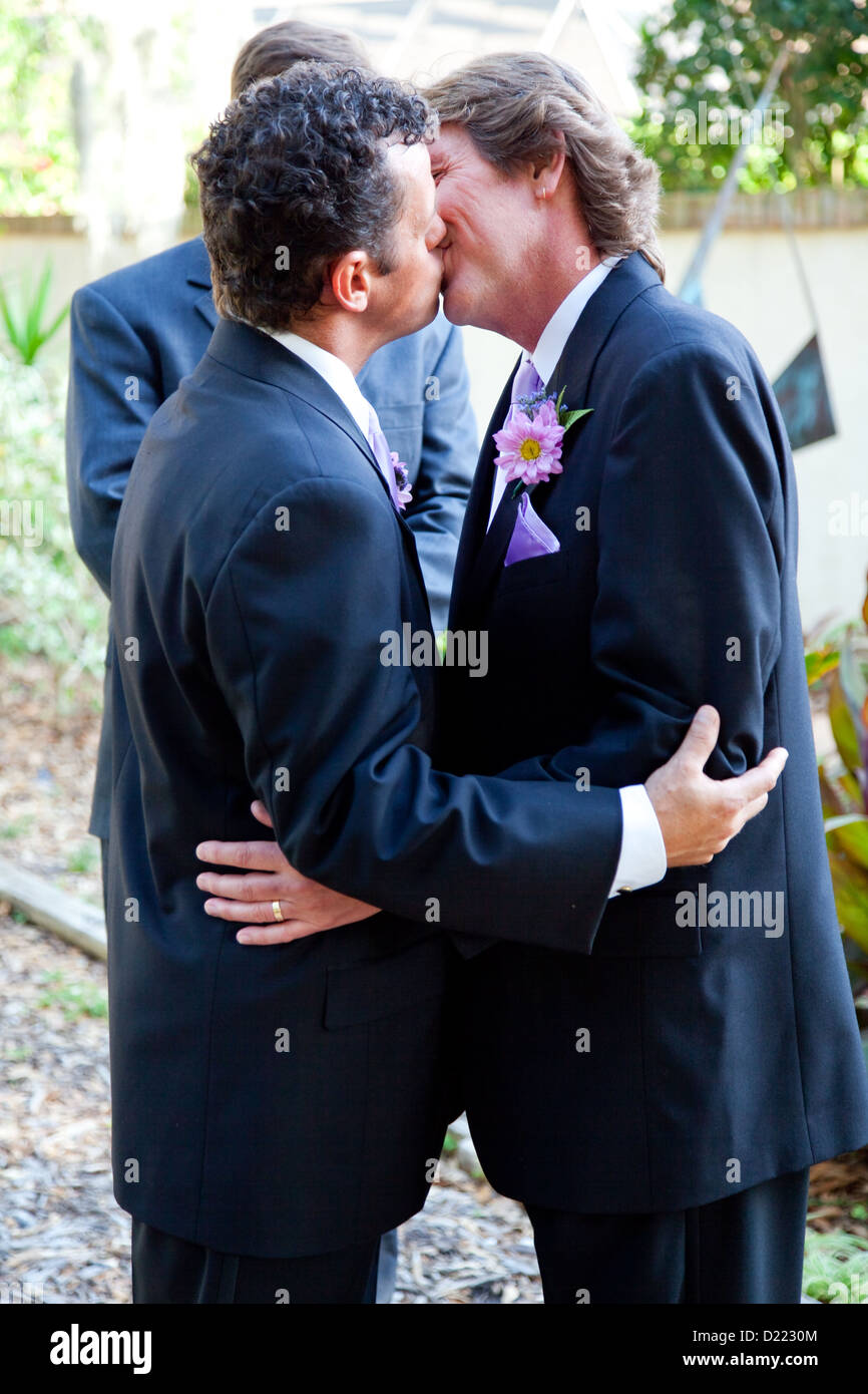 Handsome gay couple kissing at their marriage ceremony.  Stock Photo