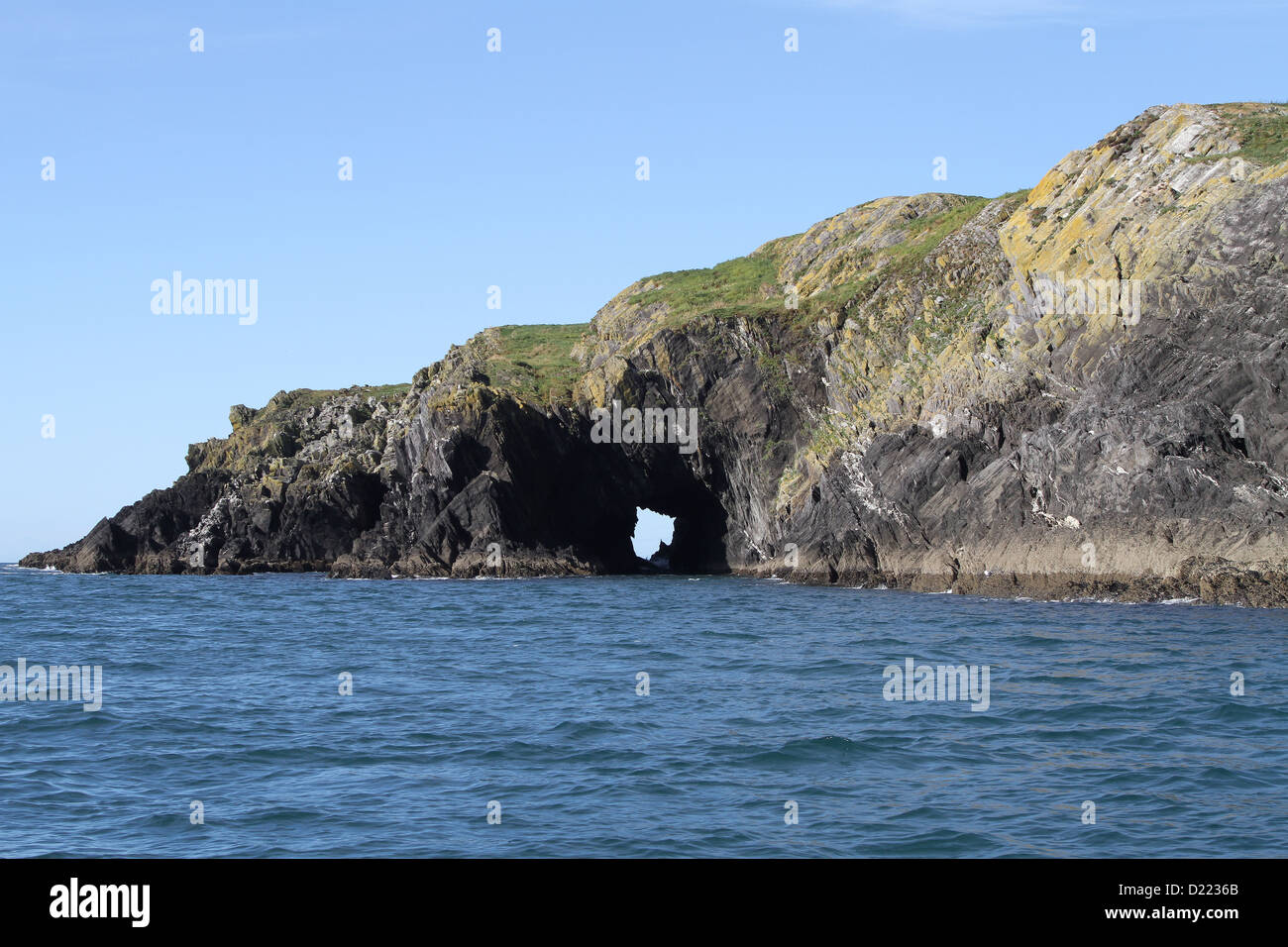 Sea arch in Ireland near Baltimore County Cork on a sunny day with blue sky over the Cork coast. Stock Photo