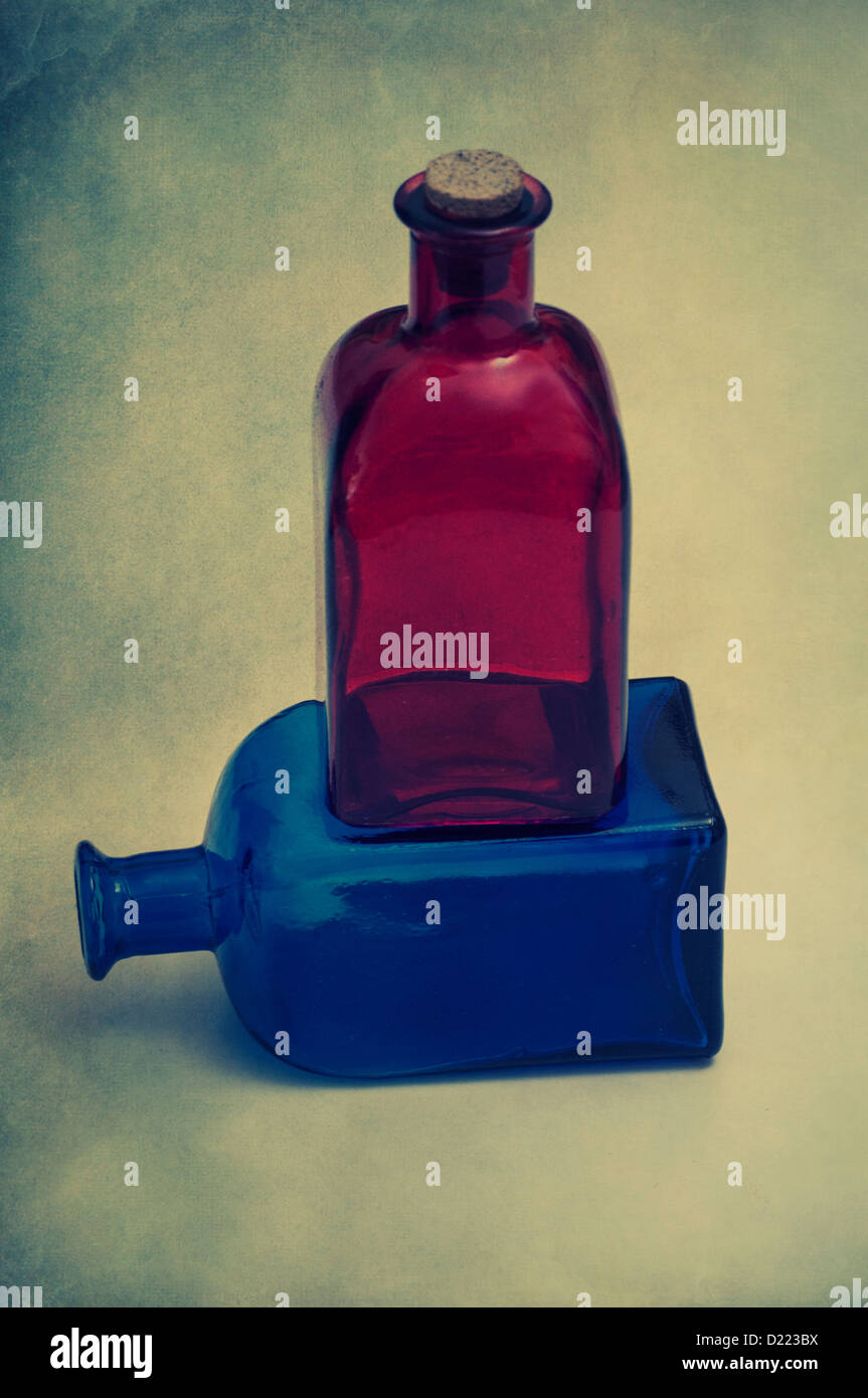 Red bottle over a blue bottle Stock Photo Alamy