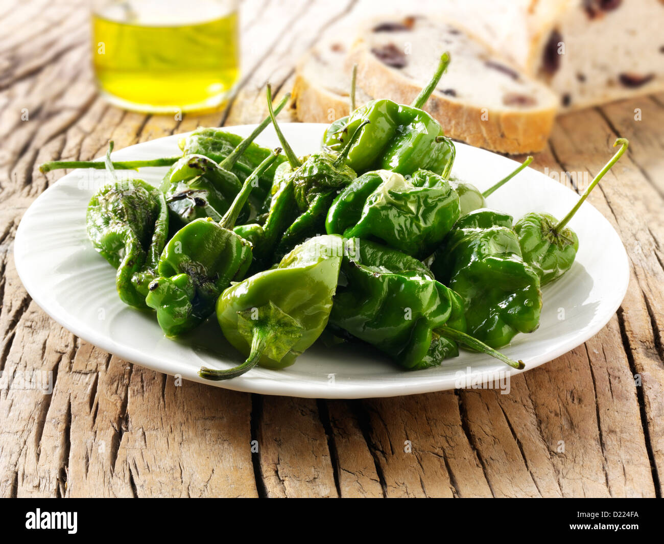 Whole griddled Padron peppers snack with sea salt Stock Photo