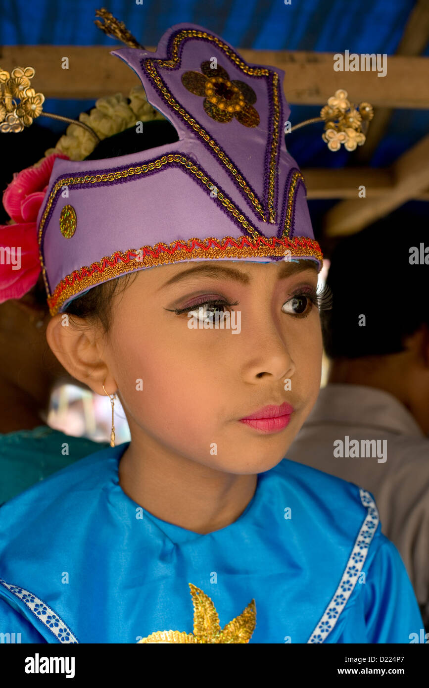 A young girl takes part in a Harvest Festival parade in the village of Tumpang, Java, Indonesia Stock Photo