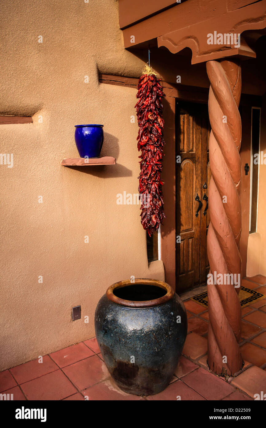 A Risto of red chilli peppers air drying outside a house in Santa Fe NM