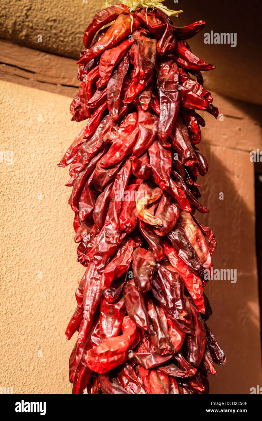 A Risto of red chilli peppers air drying outside a house in Santa Fe NM