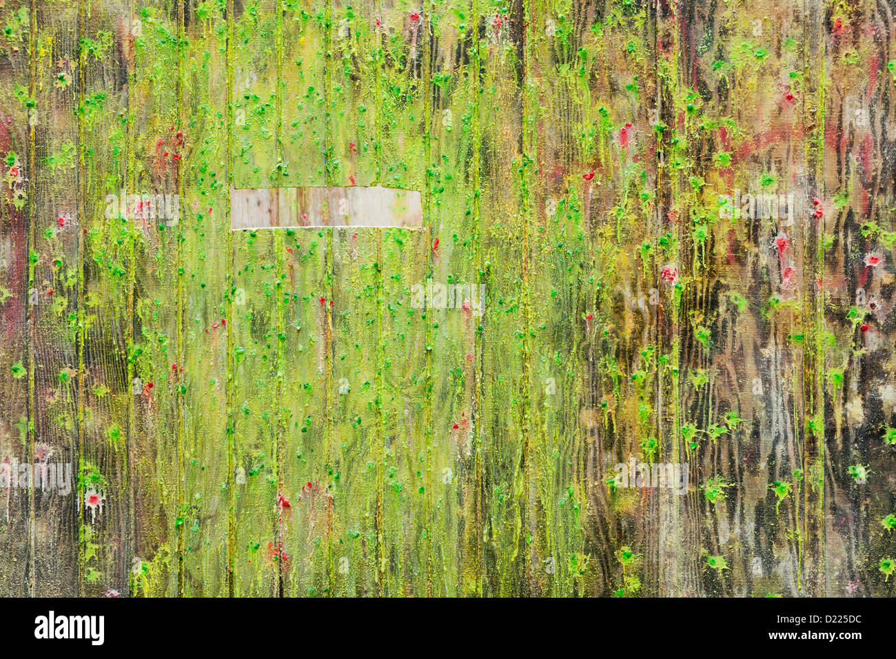 Paint covered wall and firing slit at paintball field, Oregon Stock