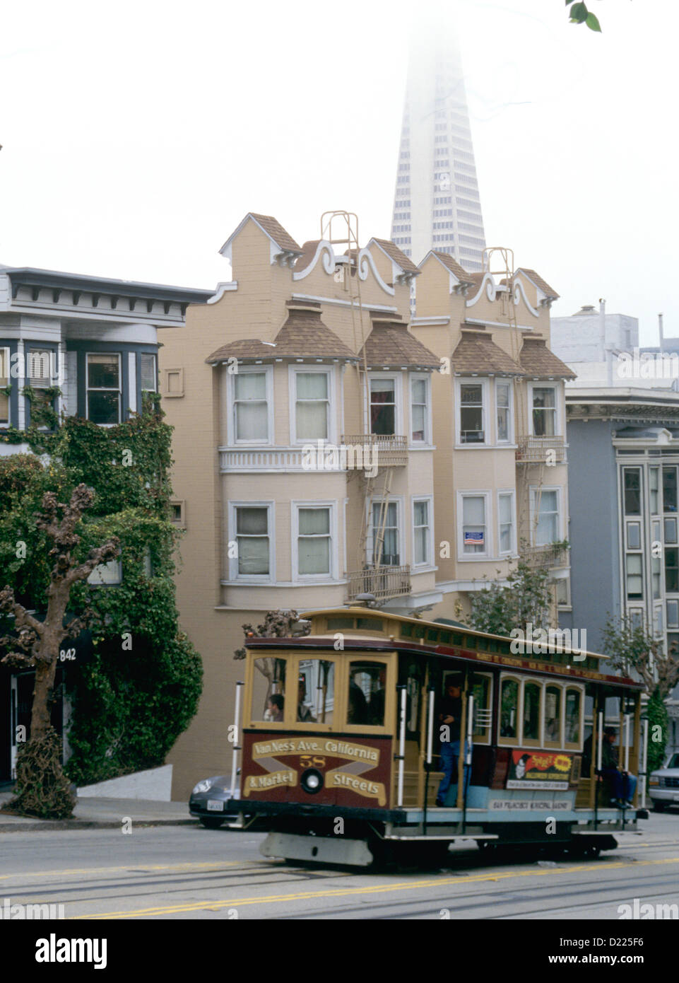 california street cable car heads up California street with transamerica pyramid in background Stock Photo