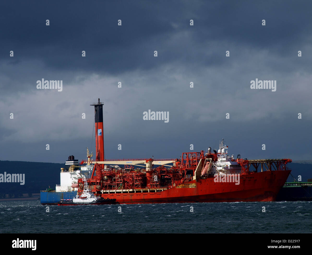 An FPSO, transfers its cargo of crude oil to a tanker at the Nigg Oil Terminla in the Cromarty Firth Stock Photo