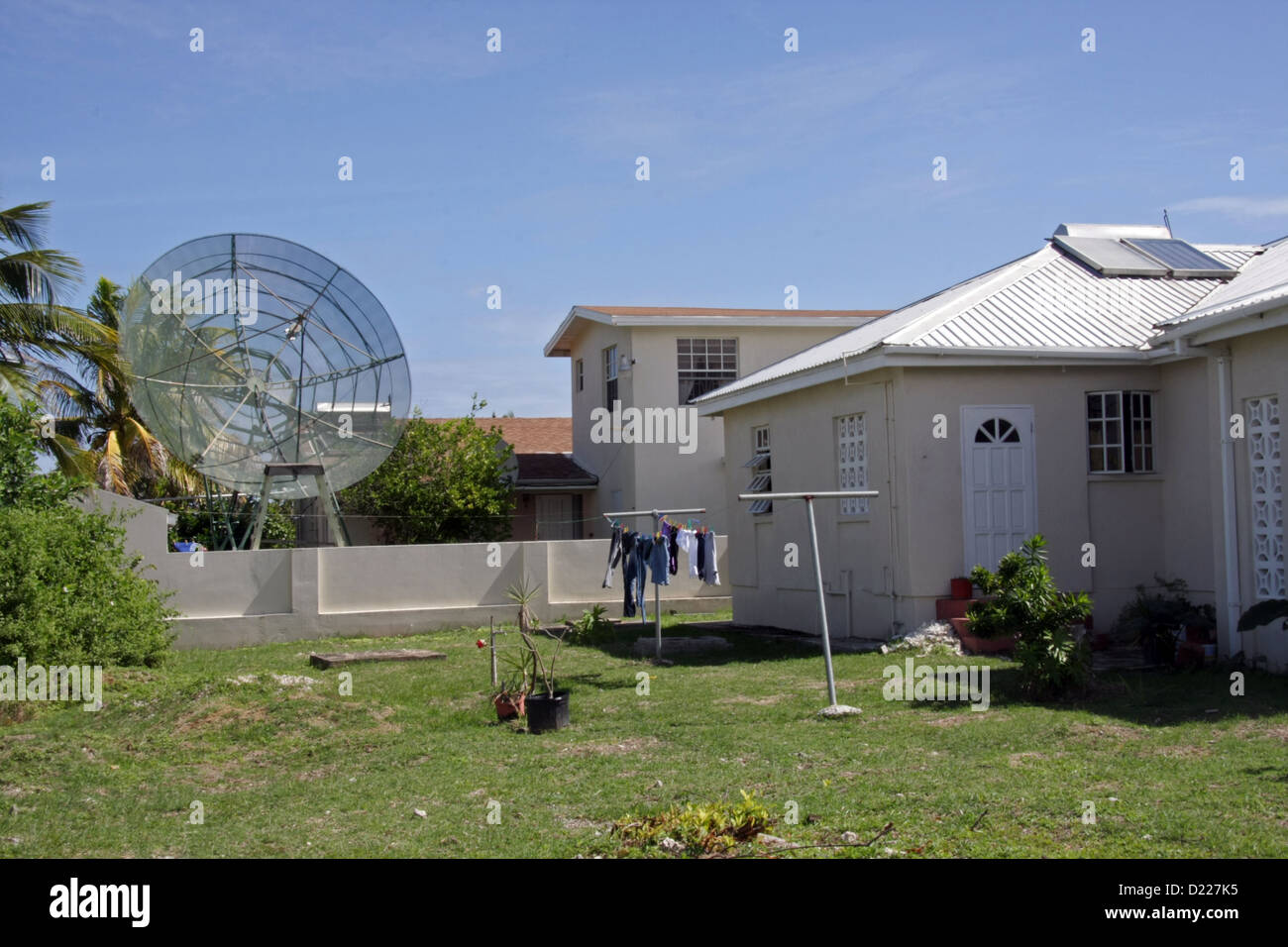 TV Satellite Dish In Back Garden Of A House In Barbados Stock Photo