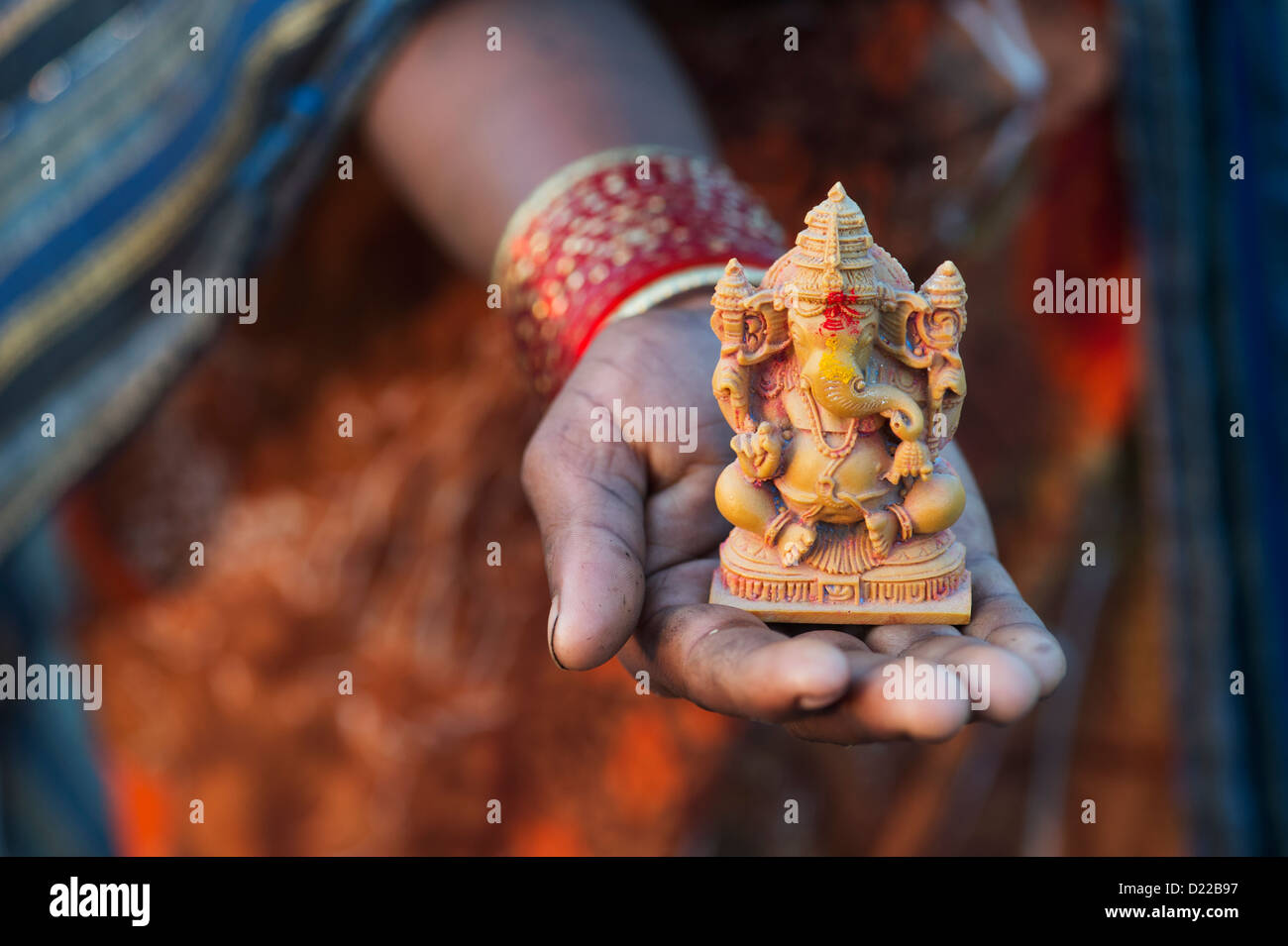 Hindu Elephant God. Indian girls hand holding Lord Ganesha statue ...