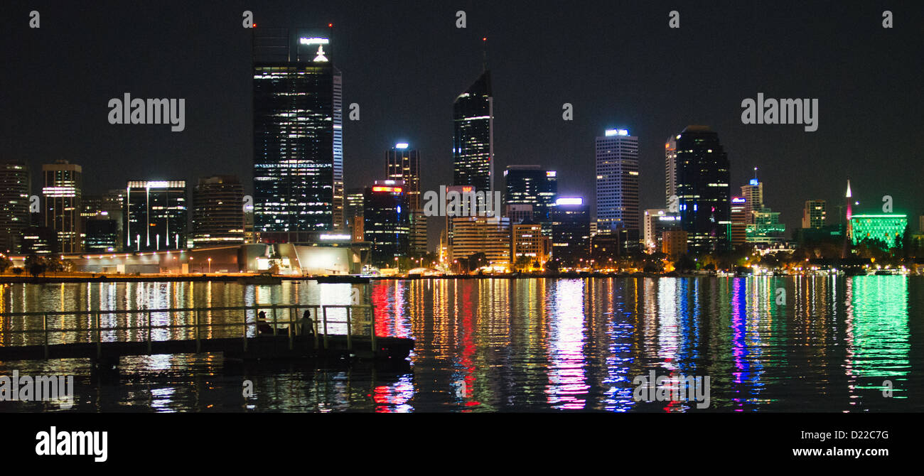 Perth Skyline Cityscape at Night. Lights Reflecting on the River with Jetty. Stock Photo