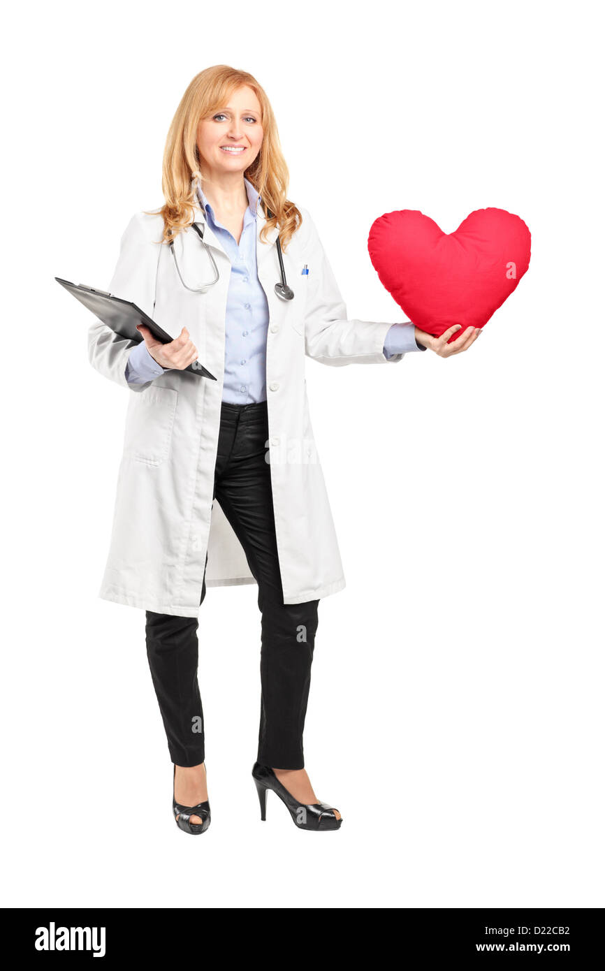 Full length portrait of a female doctor holding a red heart isolated on ...