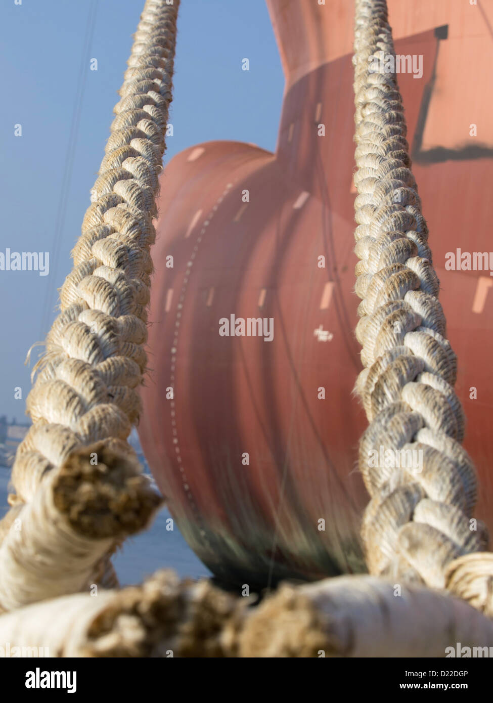 ropes on the Bulbous bow of dry cargo ship docked in harbor Stock Photo
