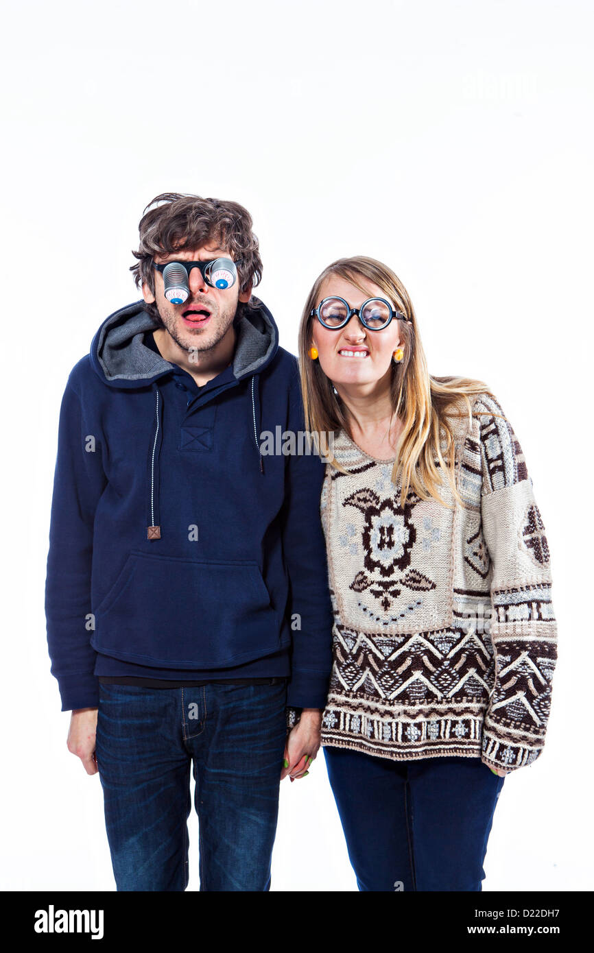Happy couple fooling around in funny glasses Stock Photo