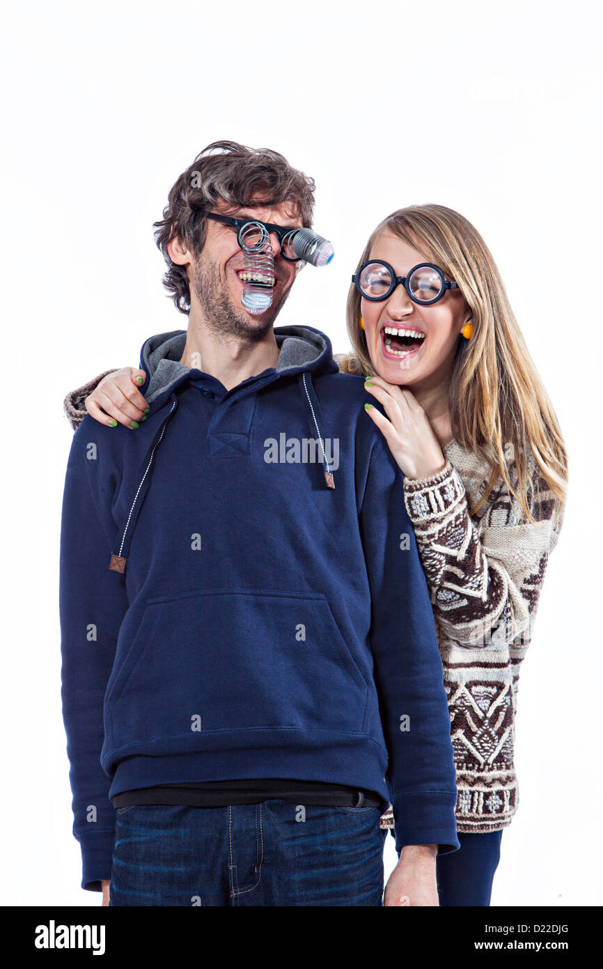 Happy couple fooling around in funny glasses Stock Photo