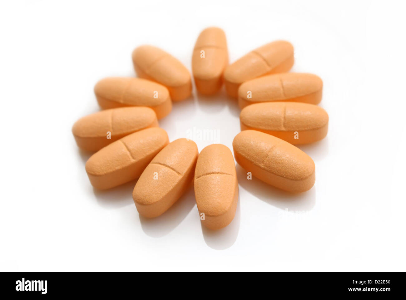 orange pills in the form of a flower isolated on white background Stock