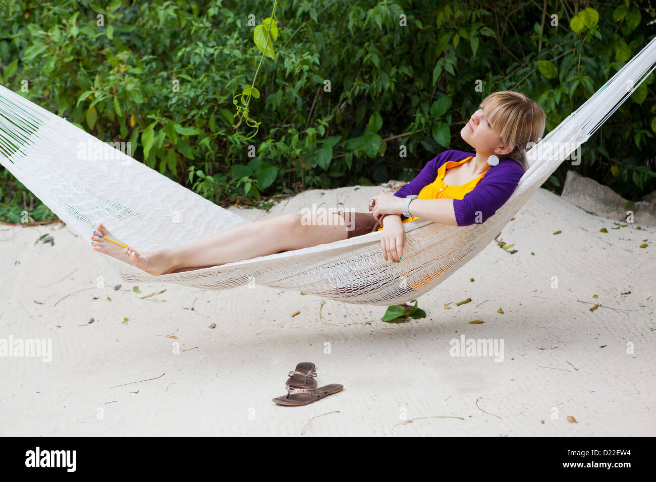 Young woman lying in a hammock Stock Photo - Alamy