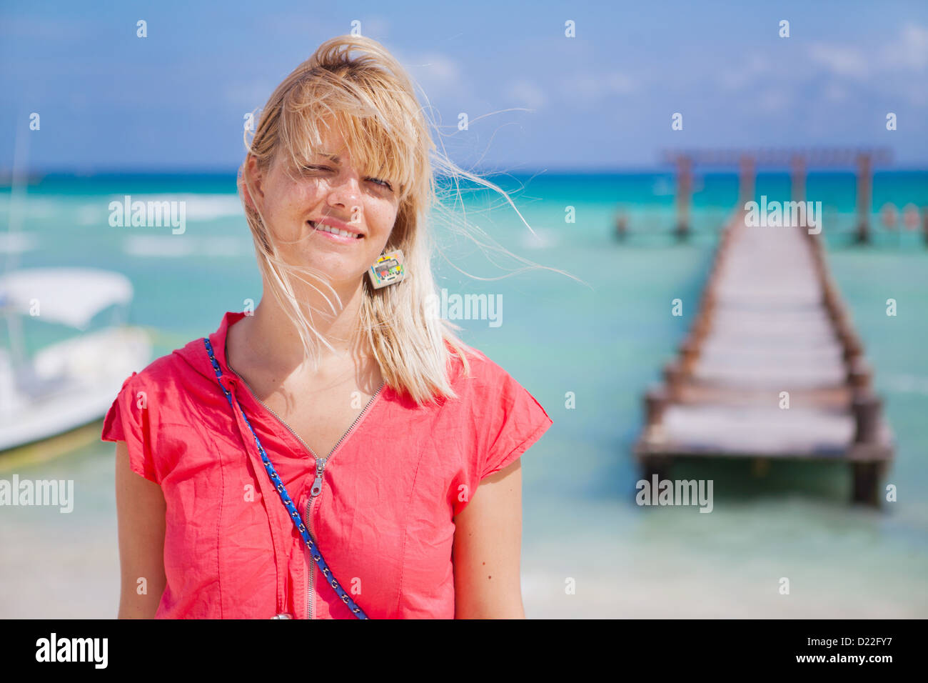 Young woman standing on the beach Stock Photo - Alamy