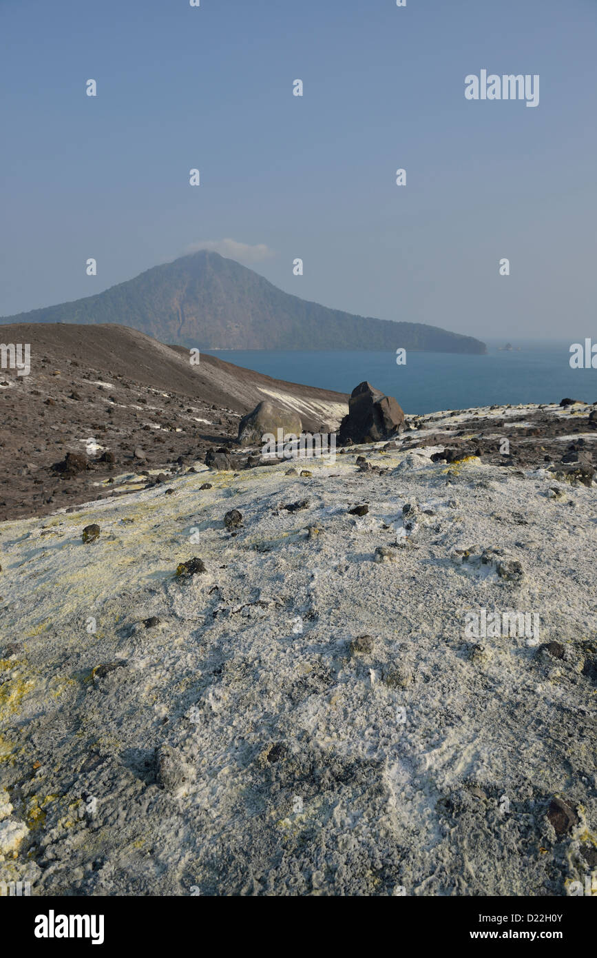 The sulphur covered slope of Anak Krakatau with the island of Rakata in the background; Western Java, Indonesia. Stock Photo