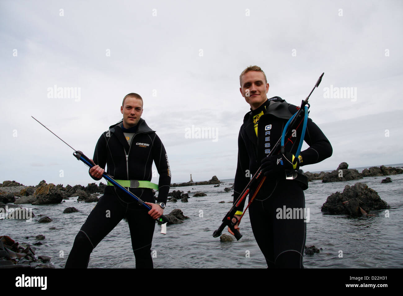 Spearfishing snorkelers pose for a photograph on the beach of Light