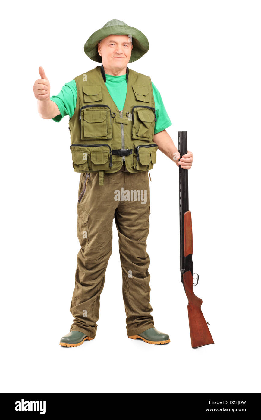 Full length portrait of a hunter holding a rifle and giving a thumb up isolated on white background Stock Photo