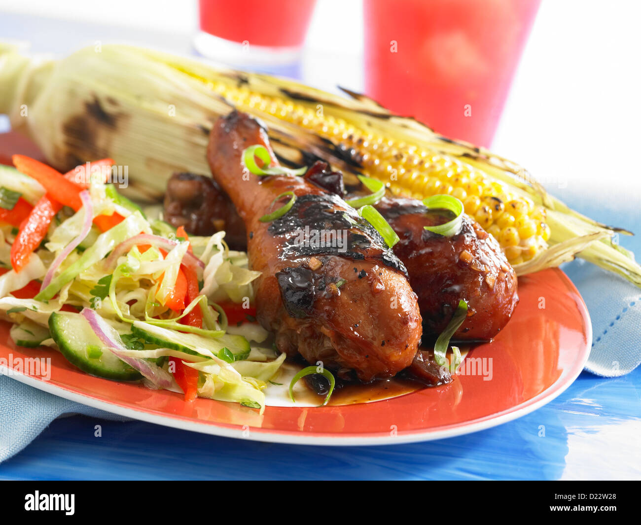 Grilled chicken served with corn on the cob and coleslaw Stock Photo