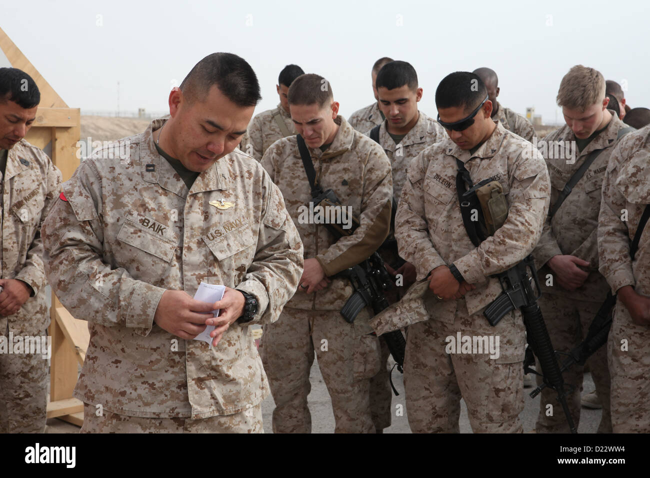 U.S. Navy Lt. Johan Baik, deputy wing chaplain, 3rd Marine Aircraft Wing (Forward), gives an invocation at Camp Bastion, Helmand province, Afghanistan, Jan. 10, 2013. Marine Aviation Logistics Squadron (MALS) 16 (FWD) dedicated their compound to Marine Co Stock Photo