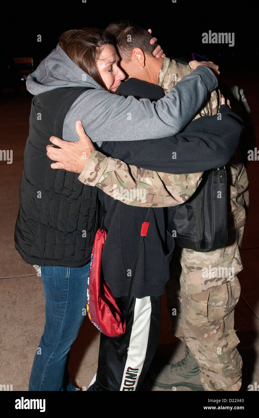 A member of the Colorado Air National guard hugs his loved one after returning home at Buckley Air Force Base Colo., Jan 10, 2013. The 140th Wing, Colorado Air National Guard enjoyed a safe return home after completing a three-month mission in support of Stock Photo