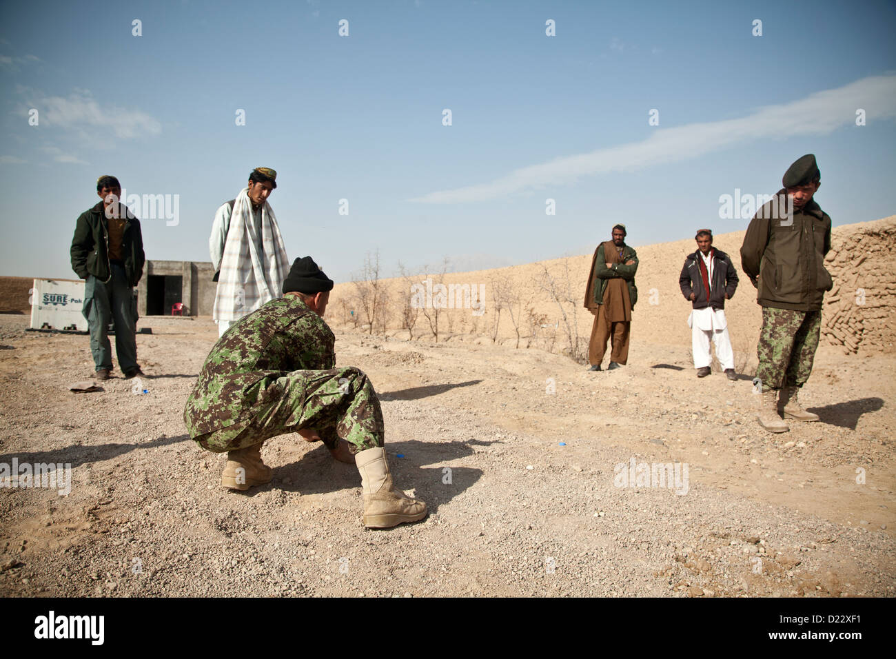 An Afghan National Army soldier demonstrates counter improvised explosive device tactics for fellow Afghan National Security Force members during training in Farah province, Afghanistan, Jan. 10, 2013. Afghan National Security Forces have been taking the Stock Photo