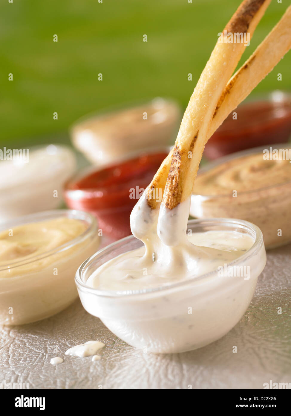 French fries dipping into ranch dressing Stock Photo Alamy