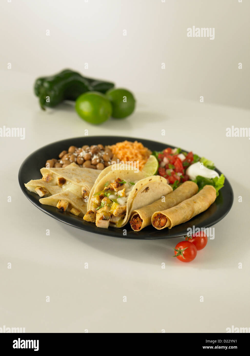 Chicken taco quesadilla taquito meal served with pinto beans and