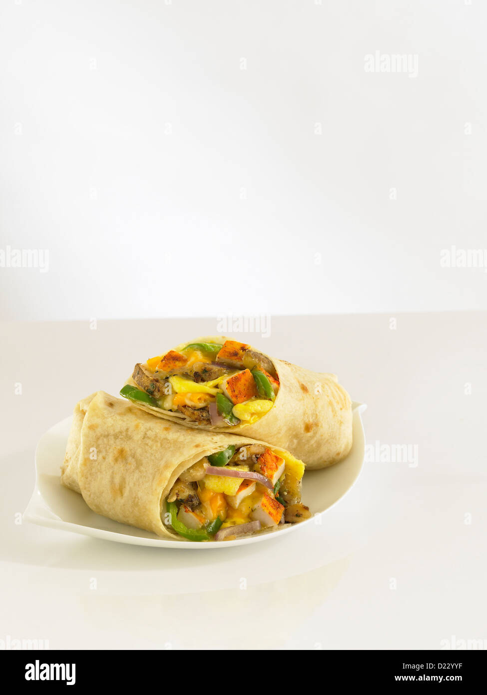 Breakfast burrito with chicken green bell peppers and onions Stock