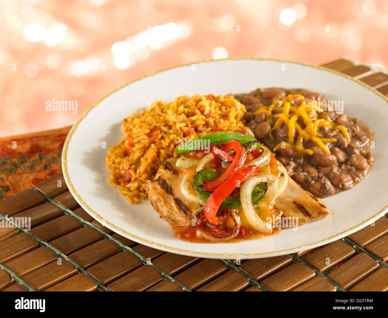 Grilled chicken topped with fajita vegetables and served with refried