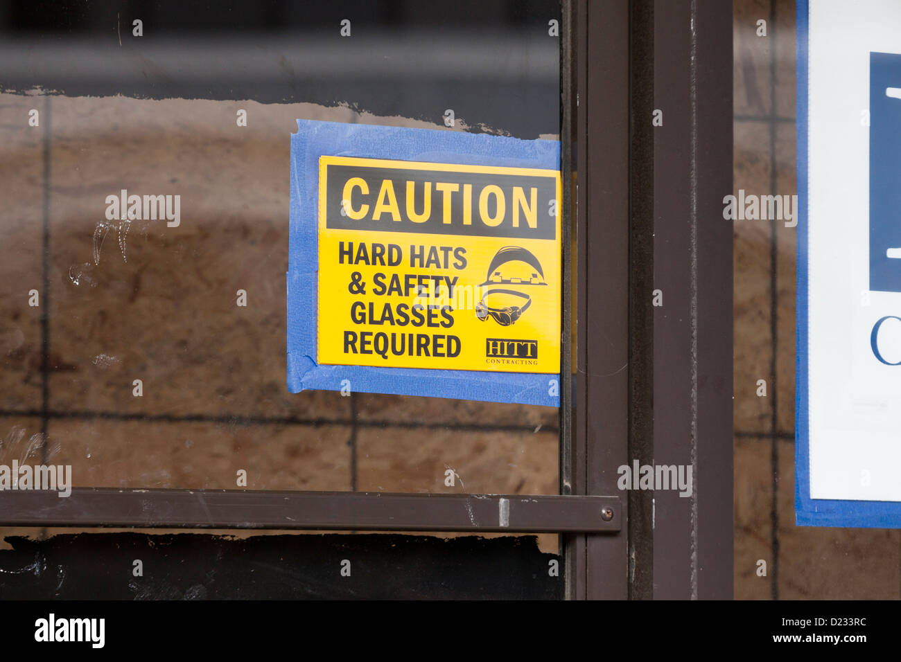 Hard hat and safety glasses required caution sign Stock Photo