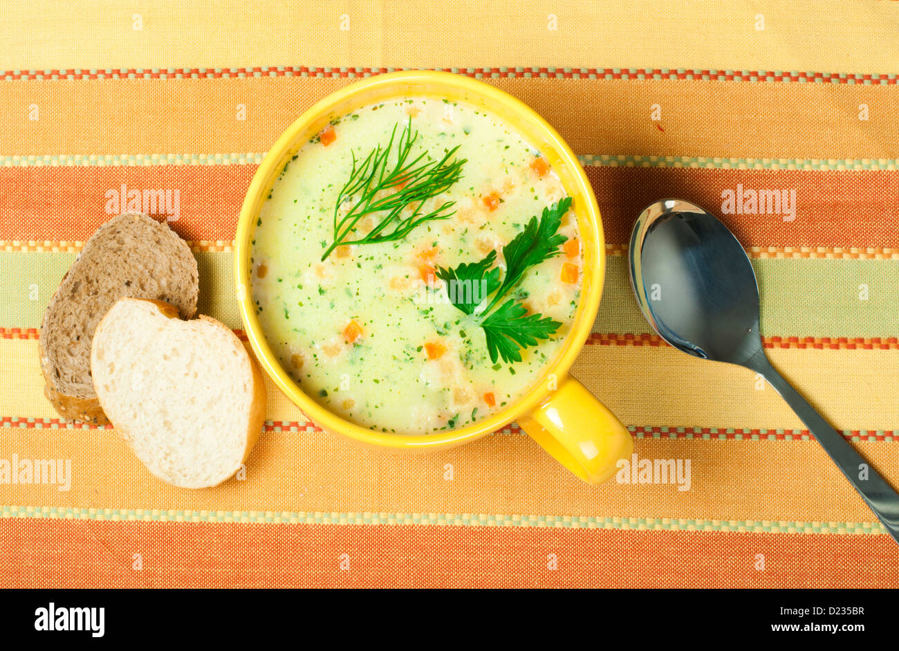 Chicken Cream Soup. Spoon and bread on the table Stock Photo