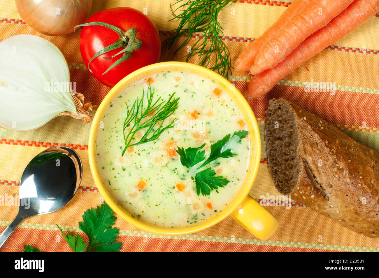 Chicken Cream Soup. Spoon and bread on the table Stock Photo