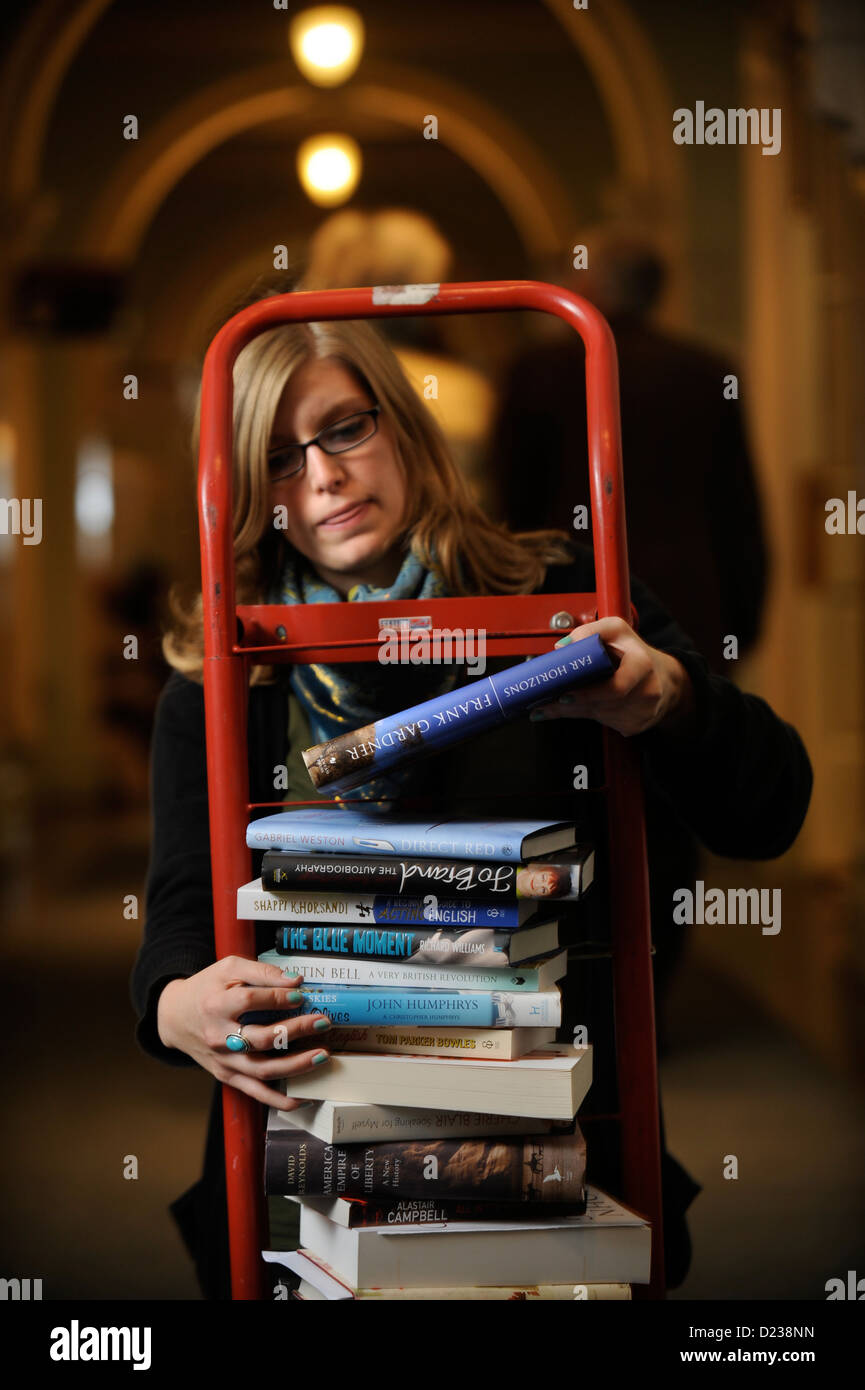 A festival organiser replaces fallen books on a sack truck at the Cheltenham Literature Festival in 2009 Stock Photo