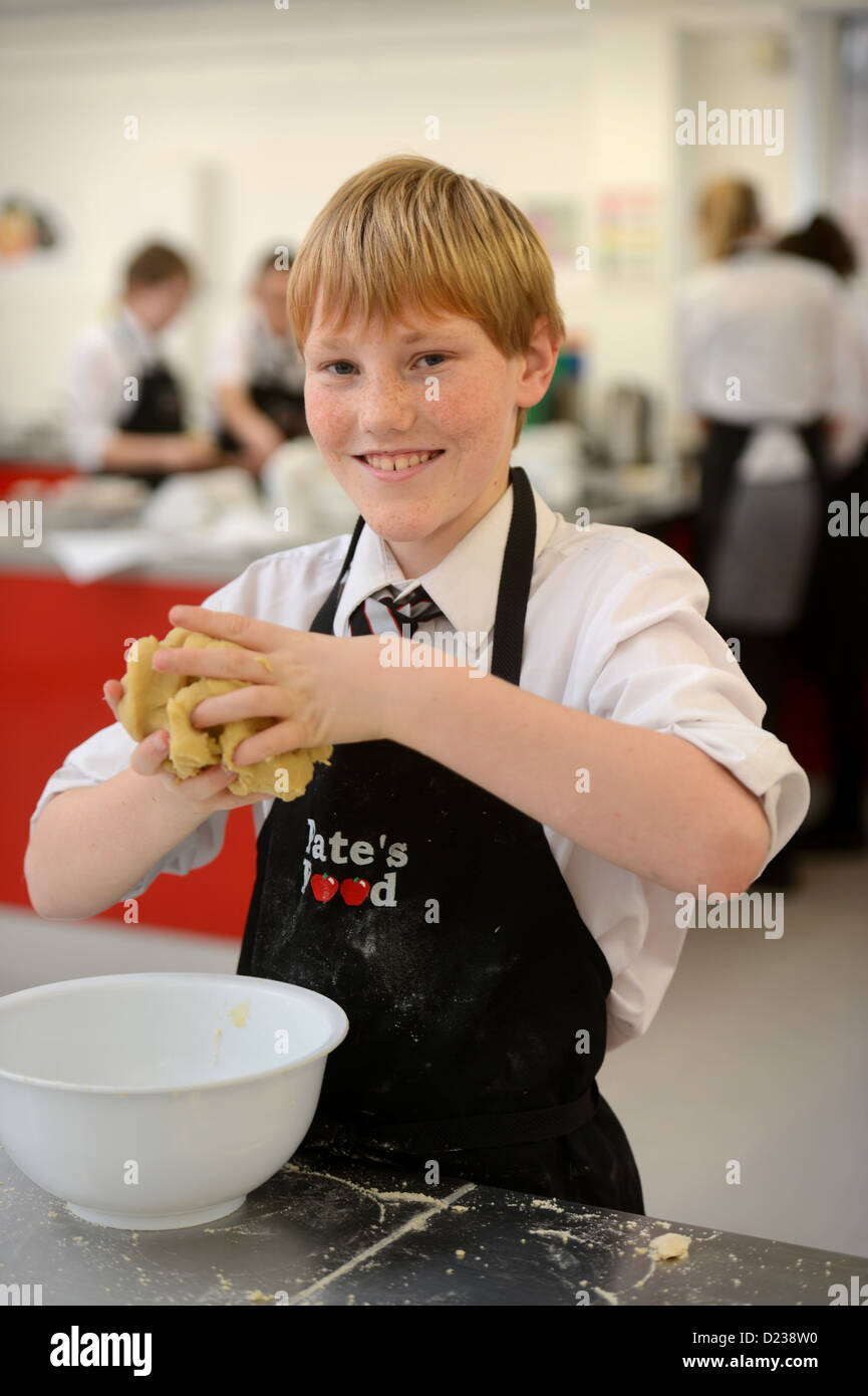 A boy kneading dough during a Food Science lesson at Pates Grammar