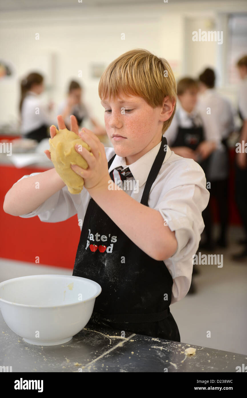 A boy kneading dough during a Food Science lesson at Pates Grammar