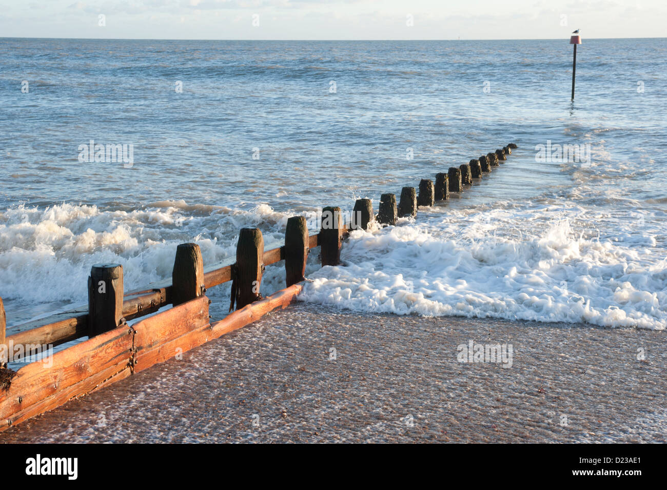 Wooden groynes on a beach in Rustington, West Sussex, UK Stock Photo
