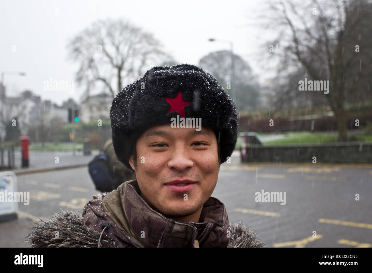 Chinese man in Chinese red star black fur hat visiting Bowness on