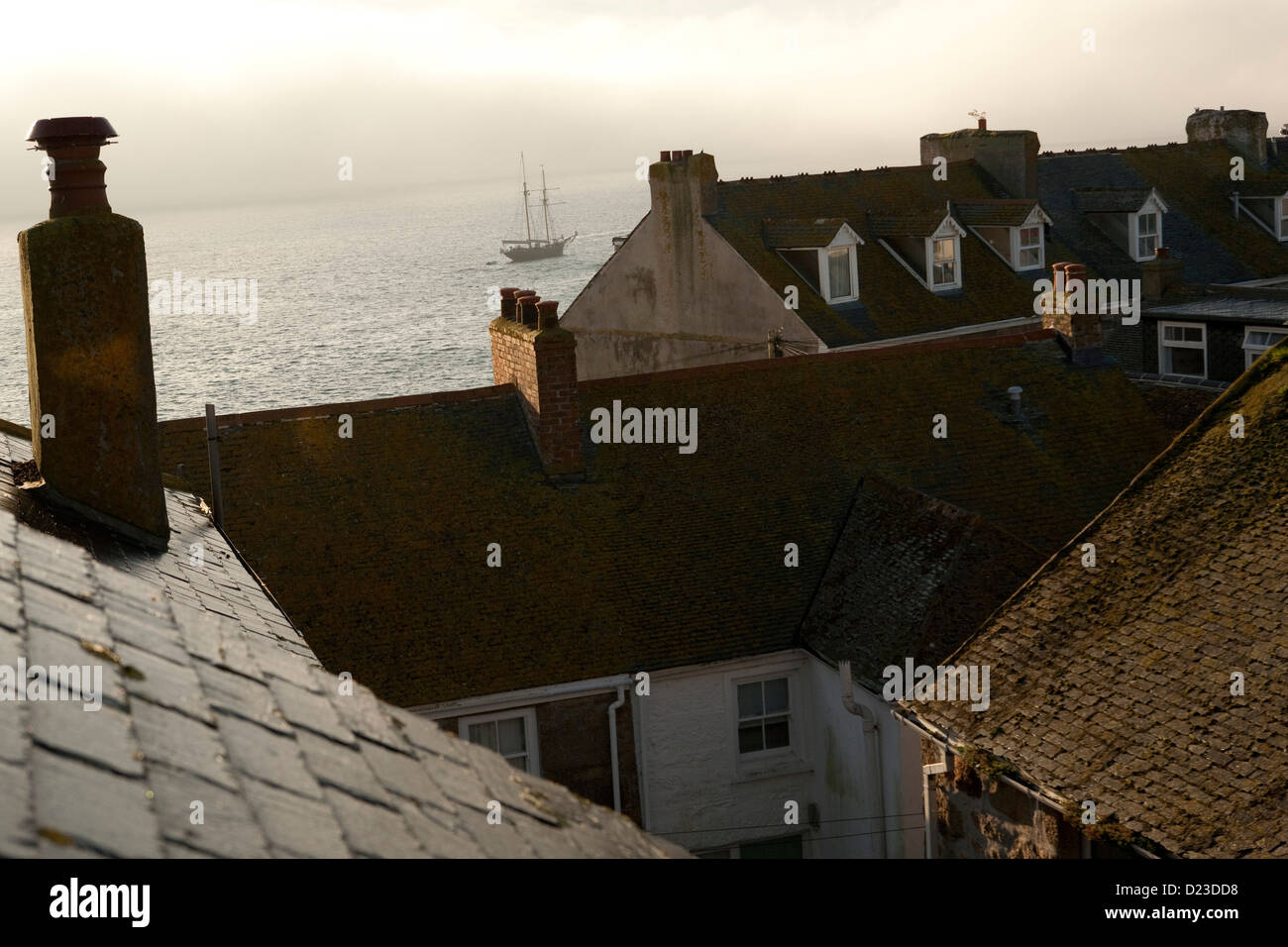 rooftops and chimneys of St Ives with the sea and harbour Stock Photo